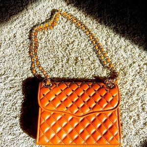 Rebecca Minkoff faux leather handbag with Gold grommet embellishments.